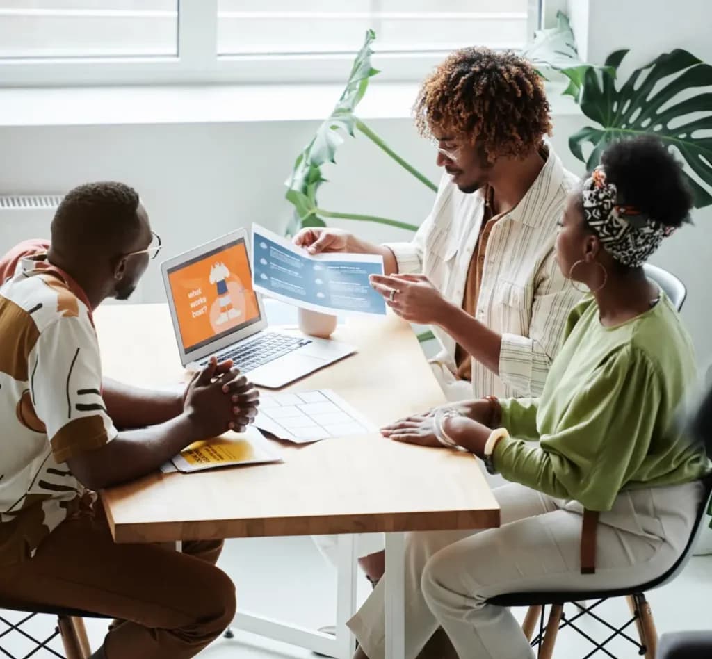 Team collaborating at a laptop